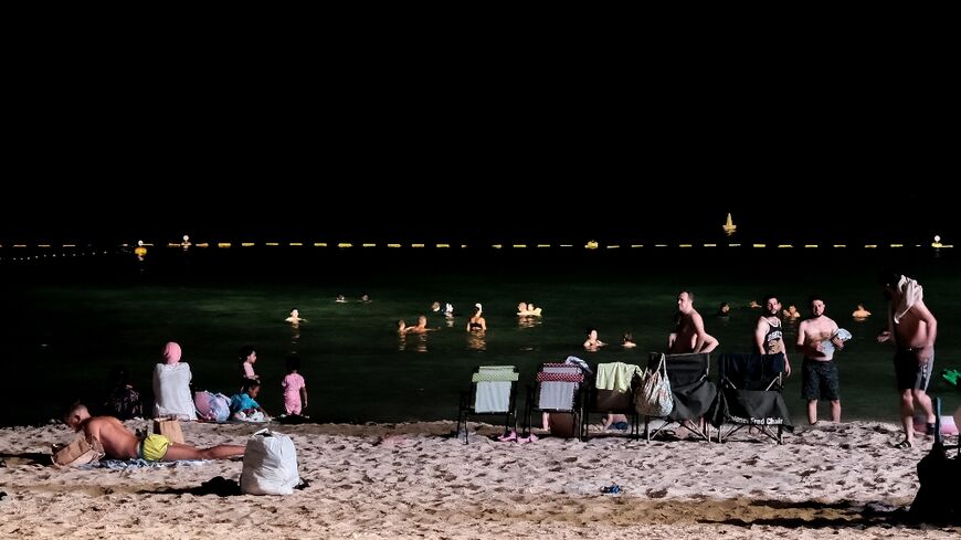 Dubai residents attempt to cool off at night at the Umm Suqeim beach as temperatures sizzle above 50 degrees Celsius (112 Fahrenheit)