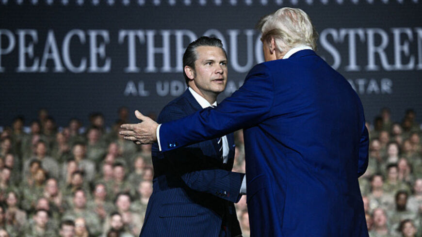 US President Donald Trump (R) greets Secretary of Defense Pete Hegseth as he arrives to address troops at the Al-Udeid air base southwest of Doha on May 15, 2025. (Photo by Brendan SMIALOWSKI / AFP) (Photo by BRENDAN SMIALOWSKI/AFP via Getty Images)