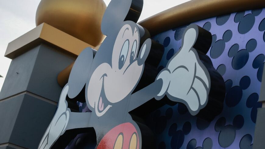 Mickey Mouse welcomes visitors near an entrance to Walt Disney World in Orlando, Florida