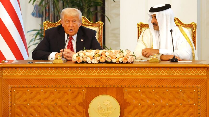 Qatar's Emir Sheikh Tamim bin Hamad al-Thani listens to US President Donald Trump at the Royal Palace in Doha