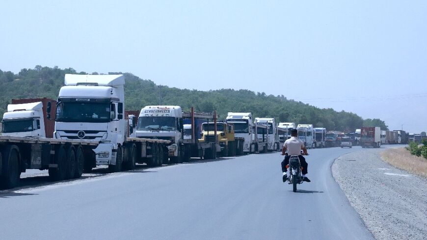 Trucks queue at the Bashmakh border crossing in Iraq, where some Iranian drivers described shortages of staple goods back home