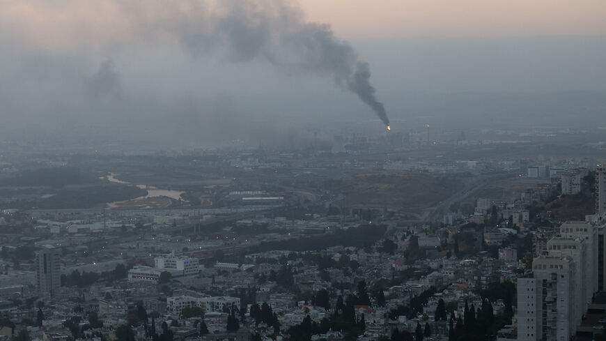 Smoke billows from a site that was hit by an Iranian missile strike in the city of Haifa early on June 16, 2025. 