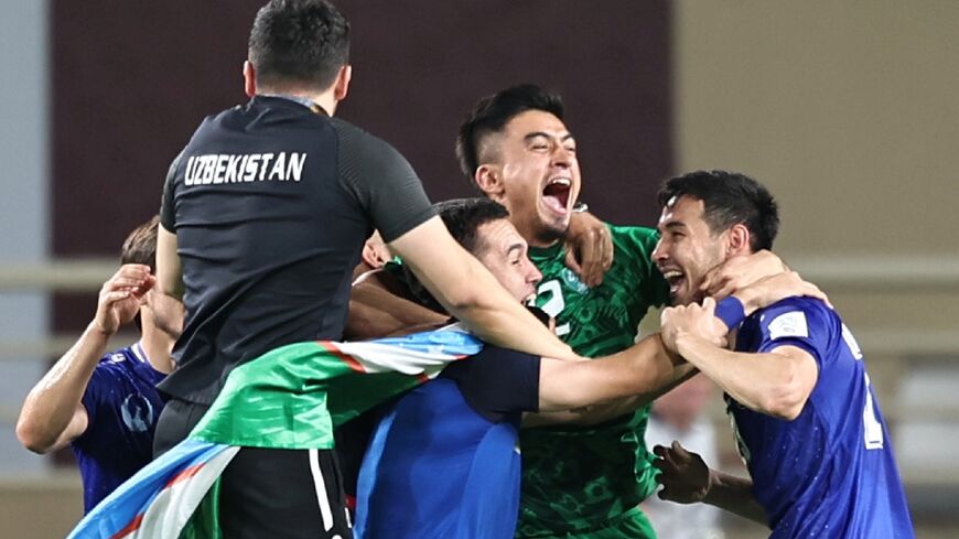 Uzbekistan's players celebrate after qualifying for the World Cup for the first time