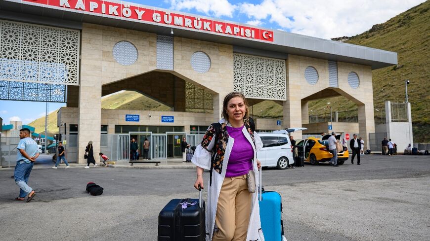 Homa, a 40-year-old Iranian, arrives in Turkey through the Razi-Kapikoy border crossing, north-eastern Turkey on June 18, 2025