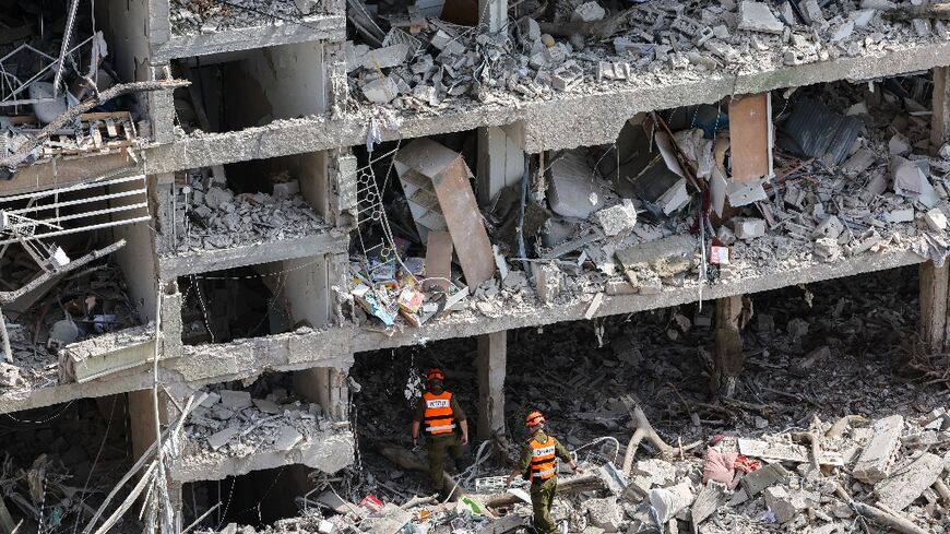 Israeli security forces and first responders gather at the site of an Iranian strike that hit a residential neighbourhood in the Ramat Aviv area in Tel Aviv