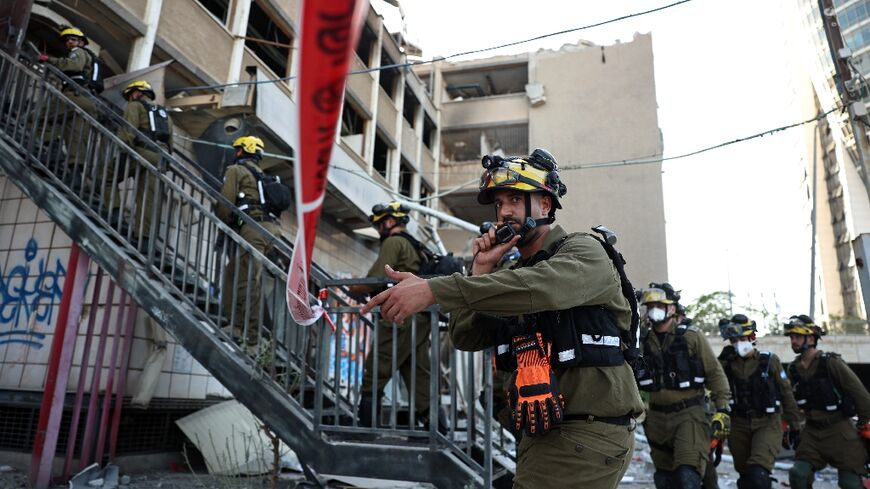 Israeli first responders at the scene of a reported Iranian strike in Haifa