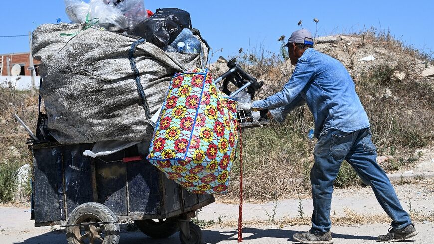 It's common to see people in Tunis weighed down by bags of plastic bottles along the roadside