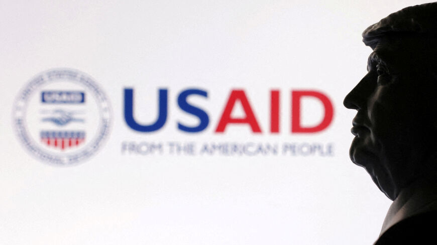 FILE PHOTO: A 3D-printed miniature model of U.S. President Donald Trump with the USAID logo in the background is seen in this illustration taken April 23, 2025. REUTERS/Dado Ruvic/Illustration/File Photo