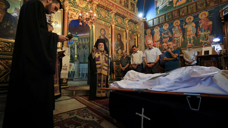 Archbishop Alexios stands in front of the bodies of Palestinian Christians Saad Salama and Foumia Ayyad, who were killed in an Israeli strike on the Holy Family Church, according to medics, as mourners attend their funeral at the Greek Orthodox Saint Porphyrius Church, in Gaza City, July 17, 2025. REUTERS/Dawoud Abu Alkas