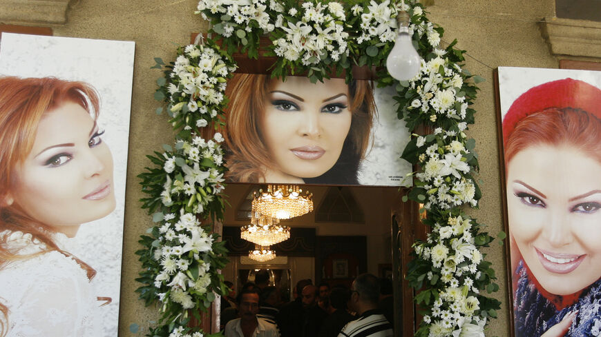 FILE PHOTO: The entrance to the home of murdered Lebanese singer Suzanne Tamim is decorated with her posters during her funeral in Beirut August 4, 2008. Picture taken August 4, 2008. REUTERS/ Mohamed Azakir/File Photo