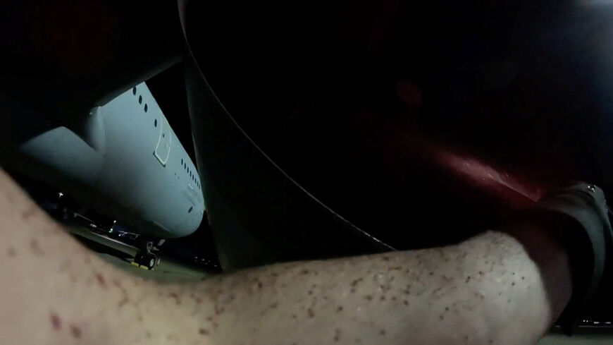 FILE PHOTO: An activist from Palestine Action sprays a military aircraft engine with red paint at RAF Brize Norton, to damage it, in Carterton, Britain, June 20, 2025, in this still image obtained from handout video. The group's action was in protest of British military assistance to Israel, claiming that they, "interrupted Britain's direct participation in the commission of genocide and war crimes across the Middle East", stating on their website. Palestine Action/Handout via REUTERS/File Photo