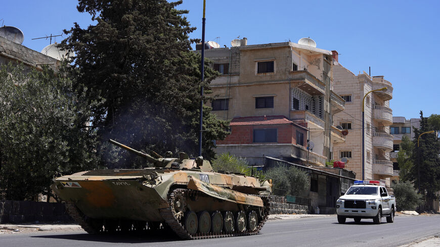 FILE PHOTO: A military vehicle drives along a street, after clashes between Syrian government troops and local Druze fighters resumed in the southern Druze city of Sweida early on Wednesday, collapsing a ceasefire announced just hours earlier that aimed to put an end to days of deadly sectarian bloodshed, in Sweida, Syria July 16, 2025. REUTERS/Karam al-Masri/File Photo