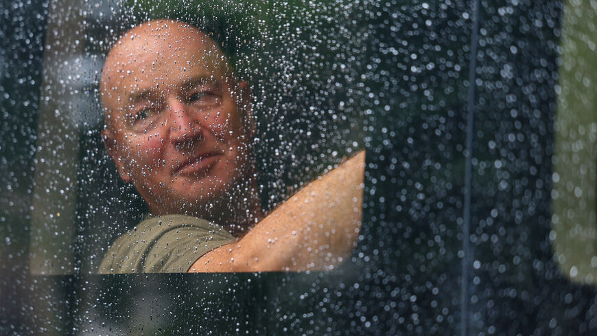 A detained demonstrator sits inside a police van, following a protest in support of the Palestine Action group in Parliament Square in London, Britain, July 19, 2025. REUTERS/Isabel Infantes