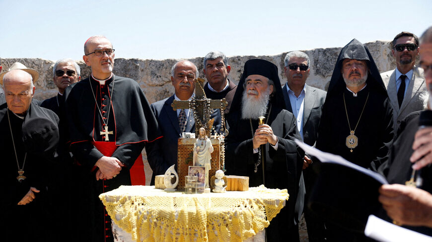 FILE PHOTO: Latin Patriarch in Jerusalem, Pierbattista Pizzaballa, and Greek Orthodox patriarch of Jerusalem, Theophilos III, look on during the visit to the town of Taybeh, a Christian village in the Israeli-occupied West Bank, following settler attacks, July 14, 2025. REUTERS/Mohammed Torokman/File Photo
