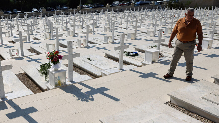A man walks next to the graves of soldiers killed in the 1974 Turkish invasion of Cyprus at the Tymvos Makedonitissas military cemetery in Nicosia, Cyprus July 20, 2025. REUTERS/Yiannis Kourtoglou