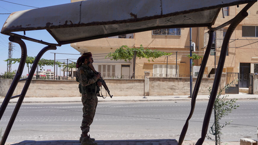 A member of the Syrian security forces stands along a street, after clashes between Syrian government troops and local Druze fighters resumed in the southern Druze city of Sweida early on Wednesday, collapsing a ceasefire announced just hours earlier that aimed to put an end to days of deadly sectarian bloodshed, in Sweida, Syria July 16, 2025. REUTERS/Karam al-Masri/File Photo
