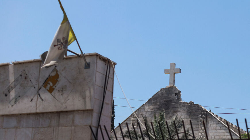 The flag of Vatican City flies as the damage is seen at the Holy Family Church which was hit in an Israeli strike on Thursday, in Gaza City July 18, 2025. REUTERS/Khamis Al-Rifi