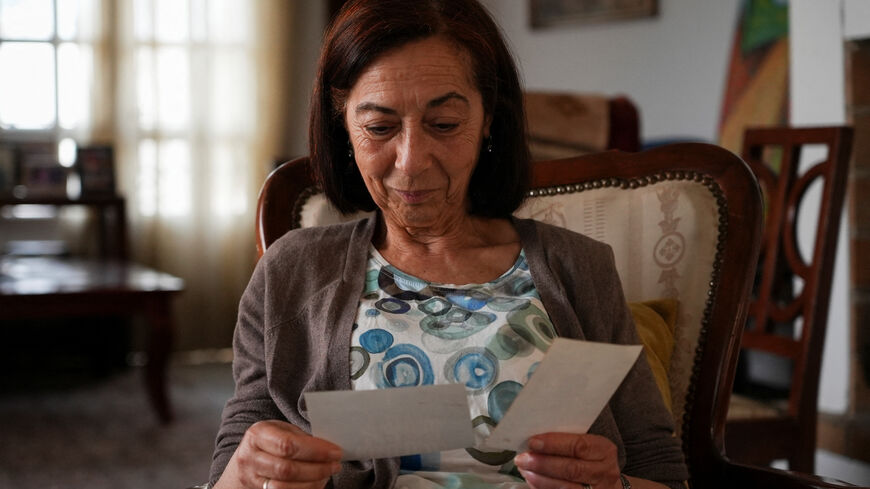 Tunisian activist Cherifa Riahi's mother Farida looks at pictures of her daughter at her house, in Tunis, Tunisia May 11, 2025. REUTERS/Stringer