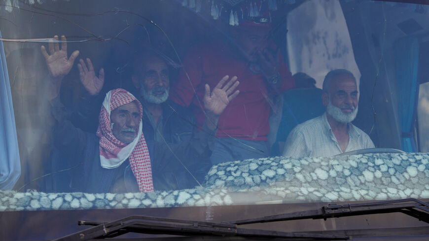 Bedouin families ride in a vehicle as they leave the village of Al-Mazraa, as residents reported calm in Syria's Sweida on Sunday after the Islamist-led government announced that Bedouin fighters had withdrawn from the predominantly Druze city and a U.S. envoy signaled that a deal to end days of fighting was being implemented, in Sweida, Syria, July 21, 2025. REUTERS/Karam al-Masri