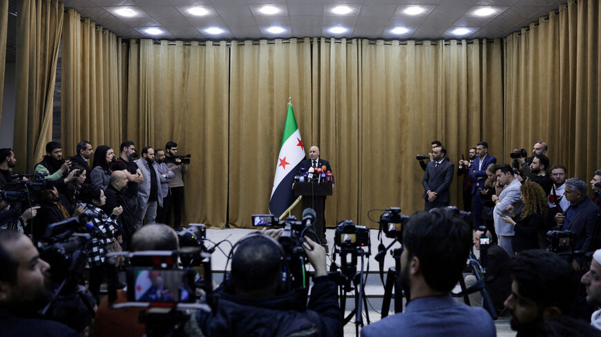 FILE PHOTO: Yaser Farhan, spokesperson of Syrian investigation committee responsible for investigating the violence in Syrian coast holds a press conference, after the reported mass killings of Alawite minority members, in Damascus, Syria, March 11, 2025. REUTERS/Khalil Ashawi/File Photo