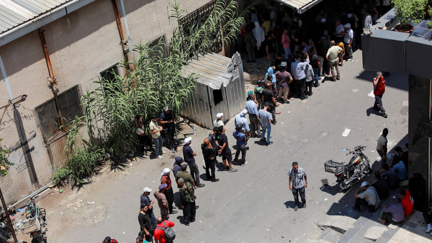 People queue to get bread in Sweida, Syria, as hundreds of Bedouin civilians were evacuated from Syria's predominantly Druze city of Sweida on Monday as part of a U.S.-backed truce meant to end days of bloodshed in southern Syria, state media and witnesses said, July 22, 2025. REUTERS/Fahed Kewan