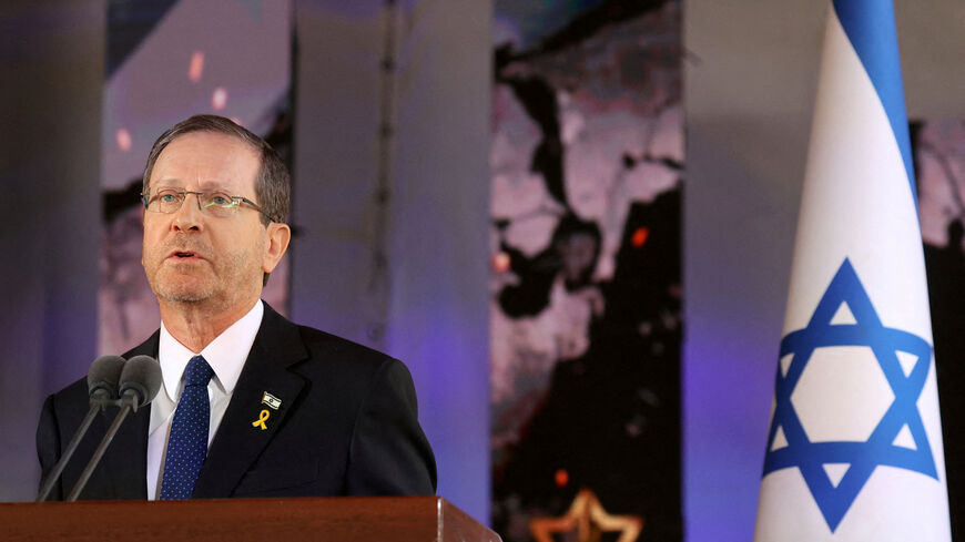 FILE PHOTO: Israel's President Isaac Herzog delivers a speech during a memorial ceremony of the Hamas attack on October 7 last year that sparked the ongoing war in Gaza, at the Mount Herzl military cemetery in Jerusalem on October 27, 2024. GIL COHEN-MAGEN/Pool via REUTERS/File Photo