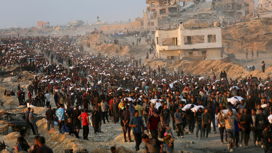 FILE PHOTO: Palestinians gather to receive aid supplies in Beit Lahia, in the northern Gaza Strip, June 17, 2025. REUTERS/Stringer/File Photo