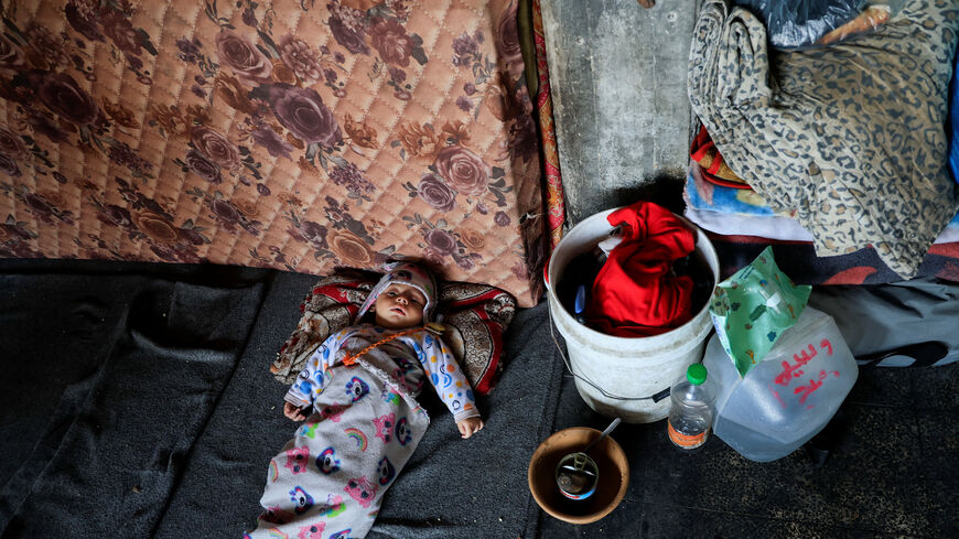 A child lies in a classroom at an UNRWA school where displaced Palestinian Majed al-Bareem and his family shelter, in Khan Younis, in the southern Gaza Strip, June 4, 2025. REUTERS/Hatem Khaled