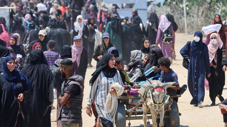 Palestinians seeking aid supplies from the U.S.-backed Gaza Humanitarian Foundation travel in an animal-drawn cart, near Rafah, in the southern Gaza Strip, July 24, 2025. REUTERS/Ramadan Abed