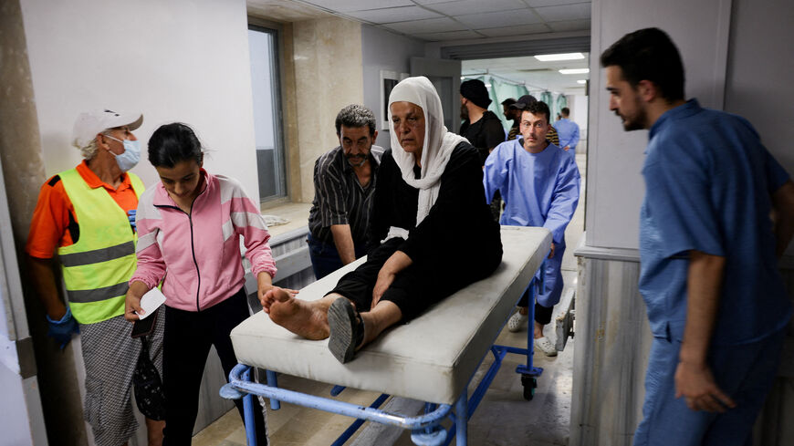 A woman is assisted at a hospital, following deadly clashes between Druze fighters, Sunni Bedouin tribes and government forces, in Syria's predominantly Druze city of Sweida, Syria July 25, 2025. REUTERS/Khalil Ashawi