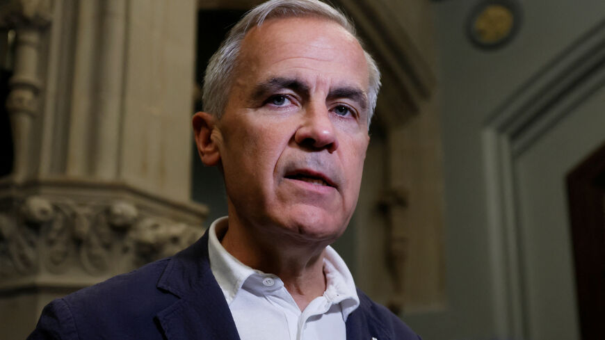 Canada's Prime Minister Mark Carney speaks to journalists outside his office on Parliament Hill in Ottawa, Ontario, Canada June 30, 2025. REUTERS/Blair Gable/File Photo