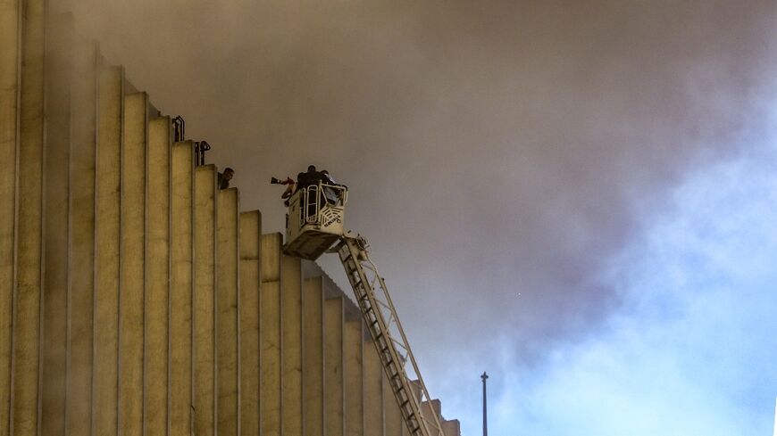Firefighters douse the flames after a fire broke out in a key telecomms hub in the Egyptian capital