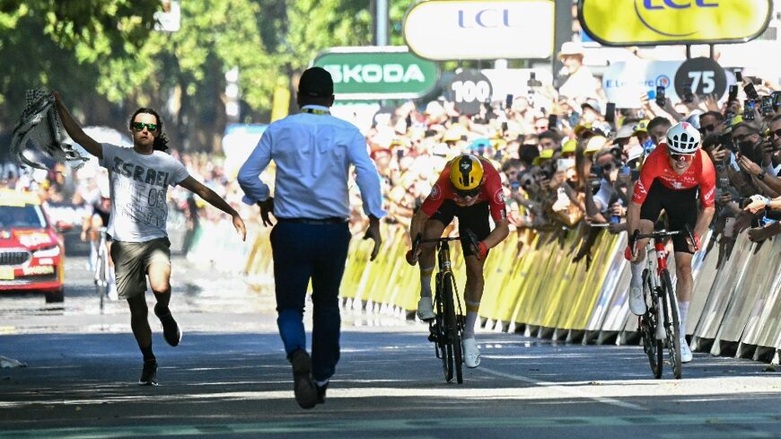 A protestor runs onto the course at the end of the 11th stage of the Tour de France in Toulouse