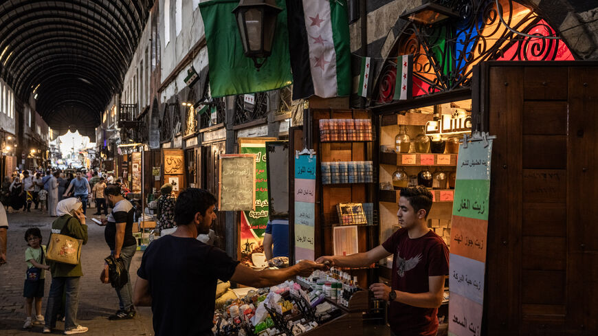 People shop in a market on June 17, 2025 in Damascus, Syria. 