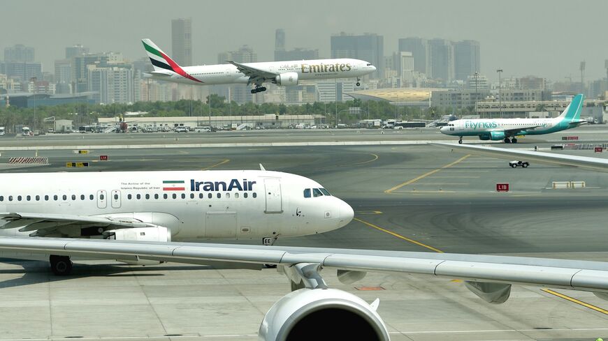 An Emirates Boing 777 lands while an Iran Air plane is taxiing, Dubai's International Airport, Sept. 14, 2017.
