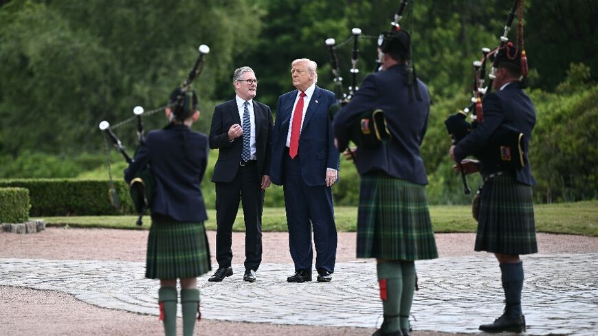 US President Donald Trump and Britain's Prime Minister Keir Starmer talk as they arrive by helicopter at Trump MacLeod House & Lodge Trump in Balmedie