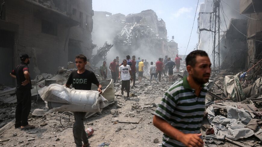 Palestinians following a strike on Gaza City, which Israel would 'take control' of under a new plan