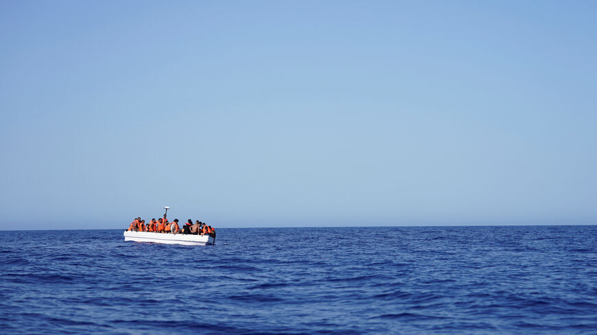 Migrants on a fiberglass boat wait to be assisted by NGO Open Arms rescue boat "Astral" in international waters south of Lampedusa, in the Mediterranean Sea, July 24, 2025. REUTERS/Ana Beltran/File Photo