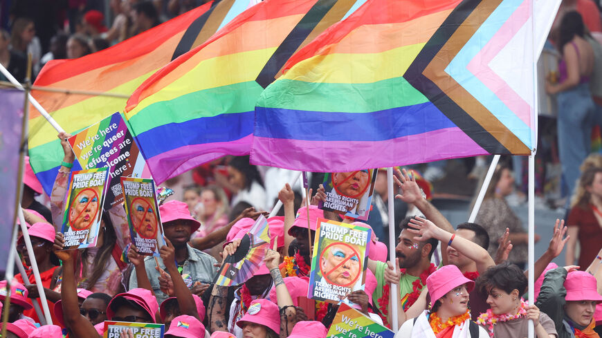 People react on a boat filled with participants, which cruises the UNESCO World Heritage recognized canals during the annual gay pride parade in Amsterdam, Netherlands August 2, 2025. REUTERS/Yves Herman