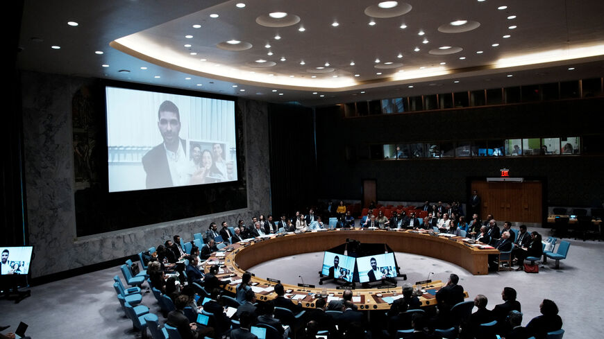 Ilay David is displayed on screen as he shows a picture of his family during a Security Council meeting at UN headquarters in New York City, U.S., August 5, 2025.  REUTERS/Eduardo Munoz