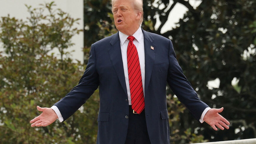 U.S. President Donald Trump shouts to reporters as he walks on the roof of the White House in Washington, D.C., U.S., August 5, 2025. REUTERS/Jonathan Ernst