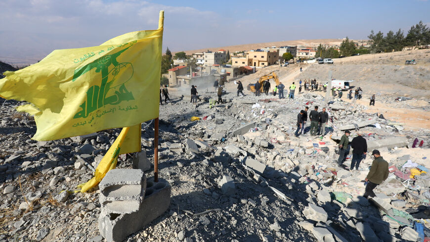 FILE PHOTO: A Hezbollah flag flutters at a site damaged in the aftermath of an Israeli strike on the town of Al-Ain in the Baalbek region, in Lebanon, November 6, 2024. REUTERS/Mohammed Yassin/File Photo
