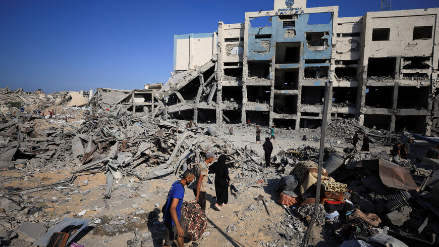 Palestinians inspect the site surrounding an evacuated UNRWA clinic where displaced people were taking shelter, following an overnight Israeli strike, in Gaza City August 6, 2025. REUTERS/Dawoud Abu Alkas