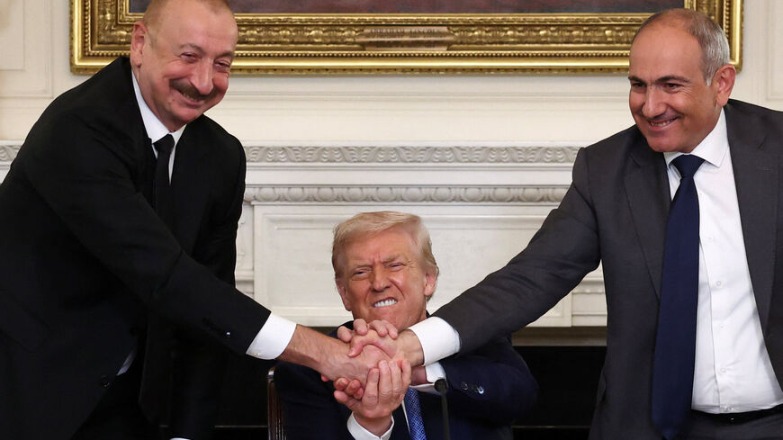 U.S. President Donald Trump holds the hands of Azerbaijan's President Ilham Aliyev and Armenia's Prime Minister Nikol Pashinyan as they shake hands between each other during a trilateral signing event, at the White House, in Washington, D.C., August 8, 2025. REUTERS/Kevin Lamarque