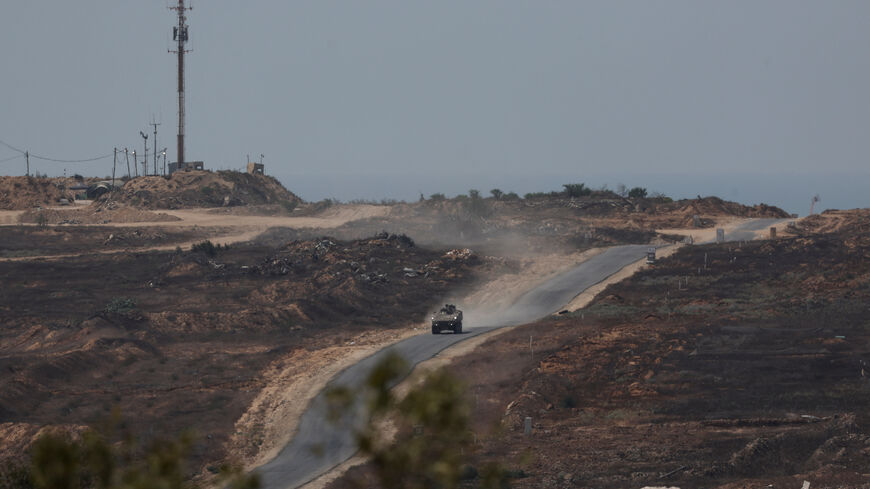 An Israeli military vehicle manoeuvres inside the Gaza strip, as seen from Israel, August 10, 2025. REUTERS/Ronen Zvulun