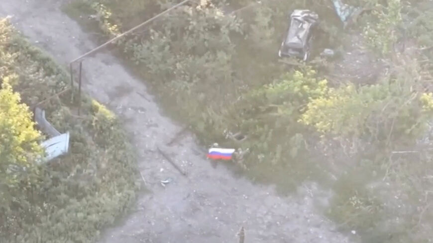 A still image, taken from footage released by the Russian Defence Ministry, shows what it said to be Russian soldiers waving a flag following the capture of Ukraine's Yablunivka (Yablonovka) settlement in the Donetsk region in the course of Russia-Ukraine military conflict, in this image from video released August 12, 2025. Russian Defence Ministry/Handout via REUTERS
