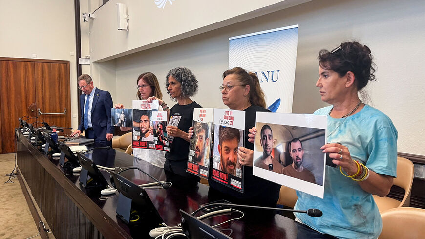 Galia David, mother of Eviatar David, Viki Cohen, mother of Nimrod Cohen, Silvia Cunio, mother of David and Ariel, and  Merav Gilboa-Dalal, mother of Guy Gilboa-Dalal, hold pictures of their sons who are hostages in Gaza, as they stand next to Permanent Representative of Israel to the United Nations in Geneva, Ambassador Daniel Meron, during a press conference, in Geneva, Switzerland, August 12, 2025. REUTERS/Emma Farge