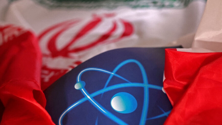 FILE PHOTO: Atomic symbol and Iranian flag are seen in this illustration taken September 8, 2022. REUTERS/Dado Ruvic/File Photo