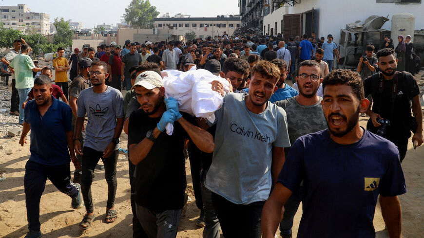 Mourners carry a body during the funeral of Palestinians killed in Israeli fire while seeking aid on Wednesday, according to medics, in Gaza City, August 14, 2025. REUTERS/Ebrahim Hajjaj