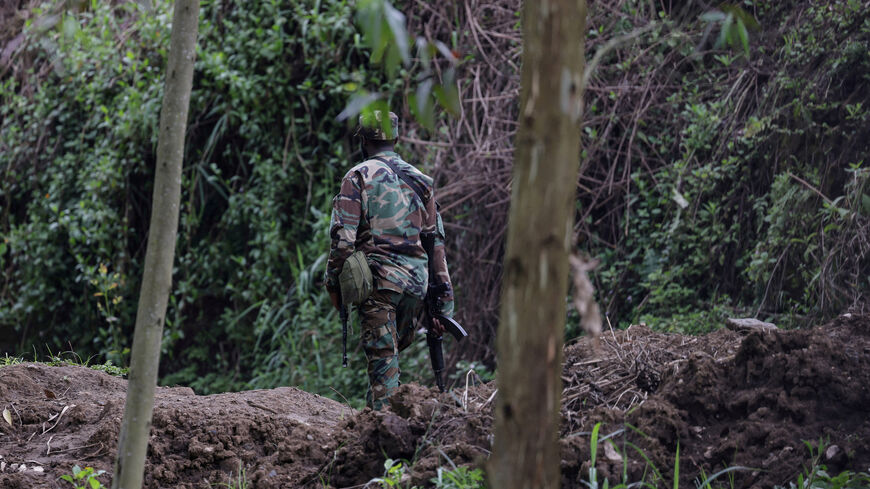 FILE PHOTO: An M23 rebel walks on the outskirts of Matanda which is controlled by M23 rebels, in eastern Democratic Republic of Congo, March 22, 2025. REUTERS/Zohra Bensemra/File Photo